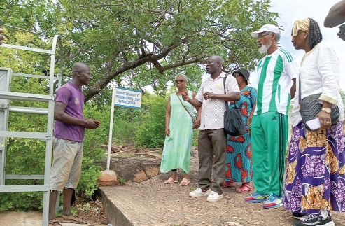 Koulbeme Mikabini (left), the Tour Guide, narrating the history of the cave to the Caribbeans