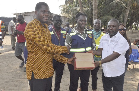 James Gunu (right), Volta Regional Minister, and Professor Nana Ama Brown Klutse (middle), EPA CEO, presenting some relief items to a member of the community James Gunu (right), Volta Regional Minister, and Professor Nana Ama Brown Klutse (middle), EPA CEO, presenting some relief items to a member of the community