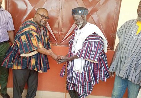 Dr Mark Kurt Nawaane, MP for Nabdam, handing over keys to a classroom to an elder in the Soliga community