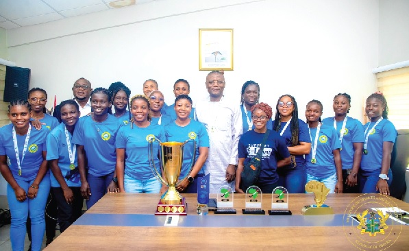 Kofi Adams (middle), Minister of Sports and Recreation, with the triumphant GRA Royal Ladies and their collection of trophies