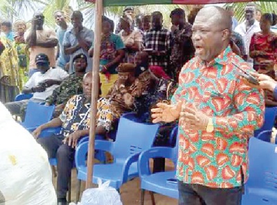 James Gunu (right), Volta Regional Minister, speaking prior to presentation of the relief items to the flood victims. RIGHT: A flood scene at Agavedzi