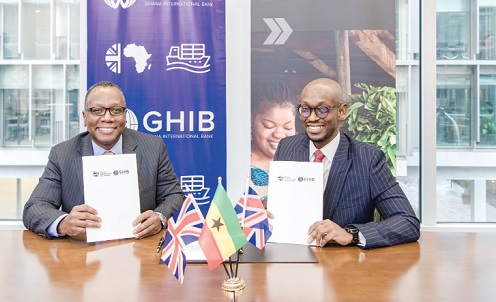 Dean Adansi (left), Chief Executive Officer, GHIB, and Kwabena Asante-Poku, Country Director, Ghana, BII, displaying documents after the signing