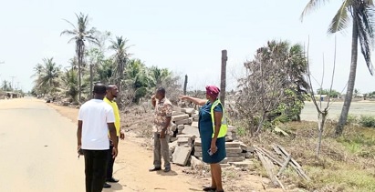 Christina Jatoe-Kaleo (right), Volta/Oti Regional General Manager of the ECG, showing the effect of the tidal waves on one of the installations to the other team members