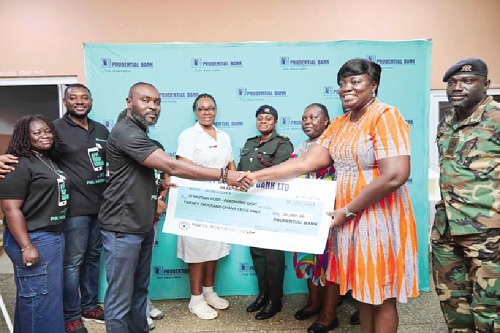 Bennet Frimpong (left), Head of Public Relations at Prudential Bank, presenting the cheque to Dr Sheila Asamoah Okyere, acting Head of the Paediatric Department of 37 Military Hospital