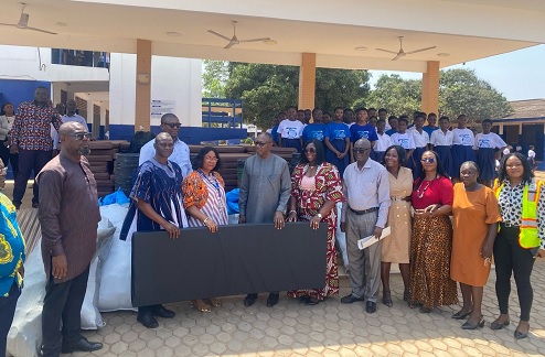  Major (retd) Dr Joseph Bikanyi Kuyon, (2nd from left), Director-General, NADMO; Dr Clement Apaak (4th from left), Deputy Minister of Education, and Linda Akweley Ocloo (3rd from left), Greater Accra Regional Minister, presenting the items to Rejoice Akua Acorlor (6th from right), Headmistress of Labone Senior High School 