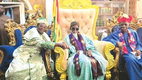 Sheikh Osmanu Nuhu Sharubutu (right), National Chief Imam, in a handshake with Nakoa Prophet Nazareth Ansah Jamson, Leader and Founder of the Israel King of Jews Church, after the presentation