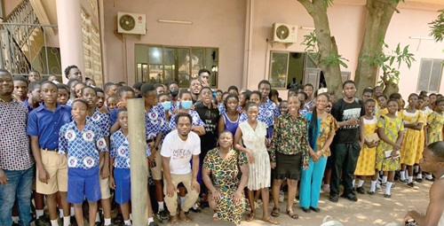 Members of the cast with some of the student-audience who watched the play
