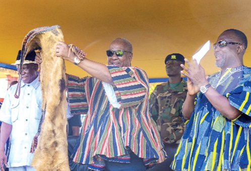 President John Dramani Mahama displaying a skin presented to him by the Tindaanas (landowners) of Bolgatanga. With him are Donatus Akamugri Atanga (left), Upper East Regional Minister, and Dr Dominic Akuritinga Ayine (right), MP for Bolgatanga East and Attorney-General and Minister for­ Justice.
