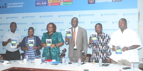 Stephen Asantilow (3rd from right), Head, Ethics and Compliance Unit, CHRAJ, launching the report. With him is Mary Awelana Addah (3rd from left), Executive Director, Ghana Integrity Initiative and Transparency International Ghana, and other dignitaries.  Picture: ERNEST KODZI