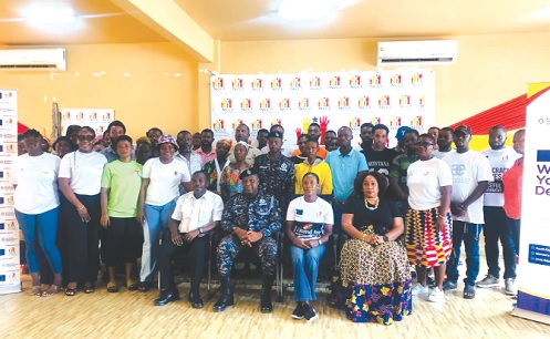 Rita Amparbin (seated 2nd from right), Director of Communications and Corporate Affairs of NCCE, with Maister Klay (seated 2nd from left), Superintendent of Police, and some staff members of NCCE and some women and youth groups