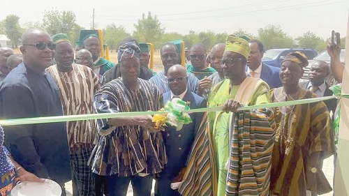 Donatus Akamugri Atanga (middle), Upper East Regional Minister, cutting the tape to inaugurate the facility  