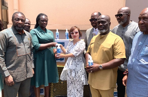 Ama Vera, Founder of EV Beauty Ghana , presenting the disinfectant to Professor Nana Ama Browne Klutse (2nd from left), acting Chief Executive Officer of the EPA 