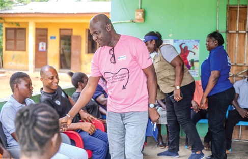 Officials of Plan International Ghana exchanging greetings with leaders of the Atonkor community in the Buem Traditional Area when they led media personnel to the place