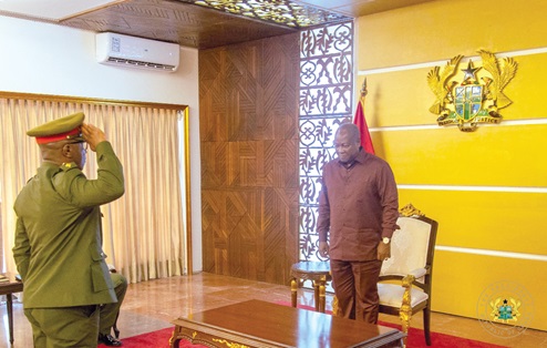 President John Dramani Mahama (right) taking a salute from Major General William Agyapong, Chief of the Defence Staff 