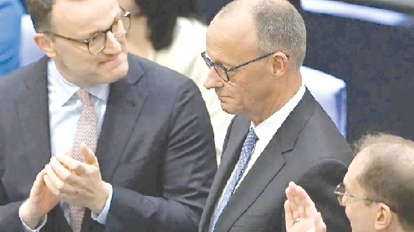 •Friedrich Merz (right) with a colleague MP in the German Bundestag 