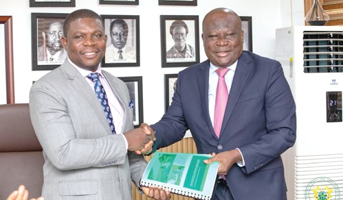 Kirk Koffi (right), Chairman of the Committee, presenting the report to Richard Gyan Mensah, Deputy Minister of Energy and Green Transition