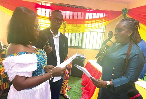 Rita Akosua Adjei Awatey (right),  Eastern Regional Minister, swearing in Linda Ahenkorah as the new DCE for Akyemansa