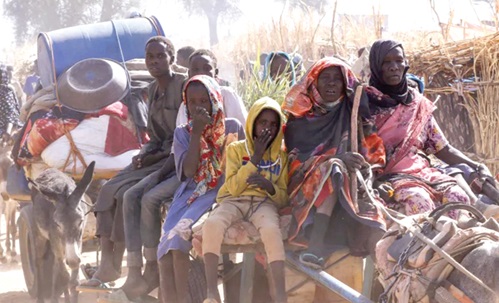 Displaced people riding an animal-drawn cart, following attacks by the rebel RSF on the Zamzam displacement camp, North Darfur, Sudan