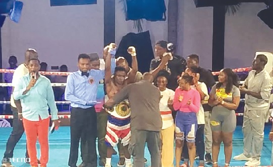 Emmanuel Mankatah Sackey being decorated with the belt after his victory