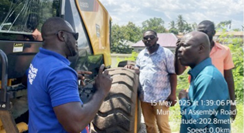 Edwin Nii Lantey Vanderpuye (right), the DRIP National Coordinator, being briefed by an official of the Obuasi West Municipal Assembly