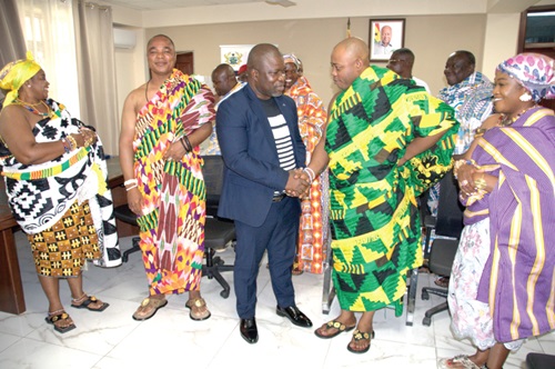 James Gunu (middle), Volta Regional Minister, in a hearty handshake with Togbe Korsi Nego VI, Manklalo of Mepe Traditional Area, while other members of the visiting delegation look on