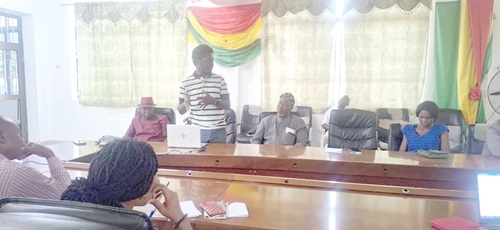 Dr Stanley Hughes-Obresi (standing), Team Leader, presenting the findings of the investigation. On his right is Donatus Akamugri Atanga, Upper East Regional Minister. INSET: Some of the dead fishes discovered during the investigation