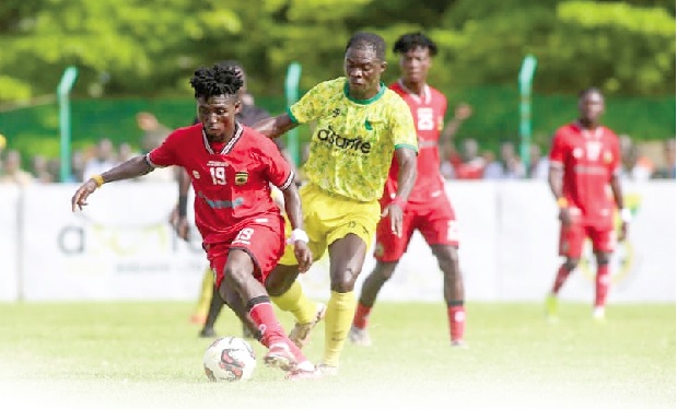 • Kotoko's Baba Yahaya controlling the ball away from his Samartex SC marker during the game yesterday