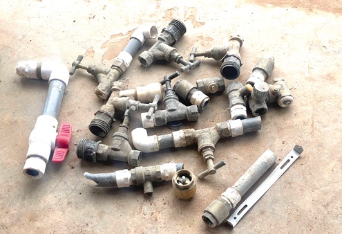 Some of the stolen stop corks and safety valves INSET: A water meter installed