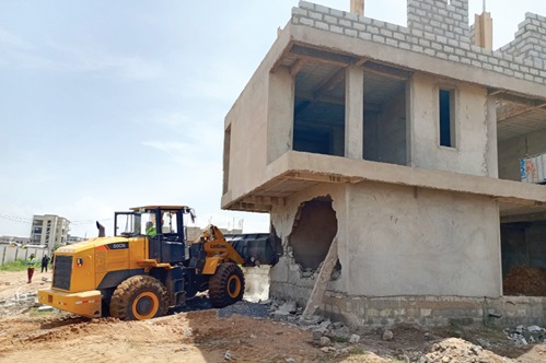 An illegal structure being demolished during the exercise