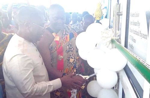 Dr Alex Adomako-Mensah (left), Board Chairman of the bank, together with Nana Dwamena Dankwa Dwebisaw, Chief of Drobonso, cutting the tape to inaugurate the new Drobonso branch building. INSET: The new Drobonso branch office building