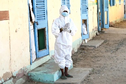 • A health worker wearing a protective outfit at a hospital where cholera patients are treated in Sudan