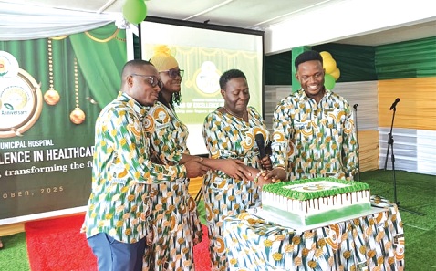 Dr Godfred Takyi (left), Medical Director, Community 22 Polyclinic, Dr Mavis Amoako (2nd from left),  Medical Superintendent, Ashaiman Municipal Hospital, with others cutting the anniversary cake.