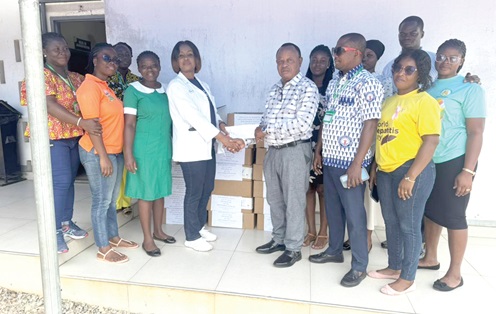Dr Sandra Osei Agyei (4th from left), Clinical Coordinator of Weija-Gbawe Municipal Hospital, receiving the items from Nana Darko Ampem Ohyeadwira
