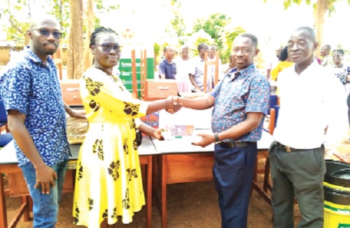 Lily Opoku Mensah (2nd from left), Corporate Social Responsibility Sustainability Officer, ASA Savings and Loans Ltd, presenting the items to Augustine Boadu-Gyamfi, Headmaster of the school Lily Opoku Mensah (2nd from left), Corporate Social Responsibility Sustainability Officer, ASA Savings and Loans Ltd, presenting the items to Augustine Boadu-Gyamfi, Headmaster of the school
