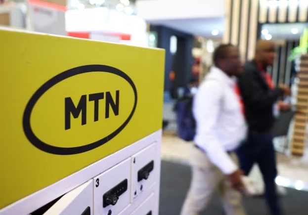 Delegates walk past the MTN logo at the Investing in African Mining Indaba 2024 conference in Cape Town, South Africa February 7, 2024. REUTERS/Esa Alexander