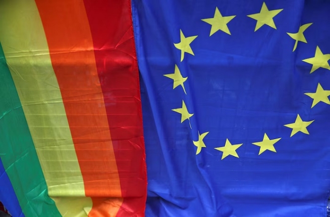 A European Union flag is displayed alongside a Rainbow flag during the annual Pride London Parade, which highlights issues of the gay, lesbian and transgender community, in London, Britain June 25, 2016. REUTERS/Neil Hall/File Photo