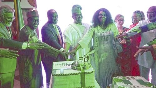 Ifedayo Moses Adeoyo (4th from left), Nigerian High Commissioner to Ghana, being assisted by Emmanuel Armah-Kofi Buah (3rd from left), Minister of Lands and Natural Resources, and other dignitaries to cut Nigeria’s 65th Independence Anniversary cake