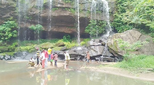 Some revellers at the foot of the waterfall Some revellers at the foot of the waterfall