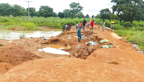 Some residents patching portions of the road to ease the situation Some residents patching portions of the road to ease the situation