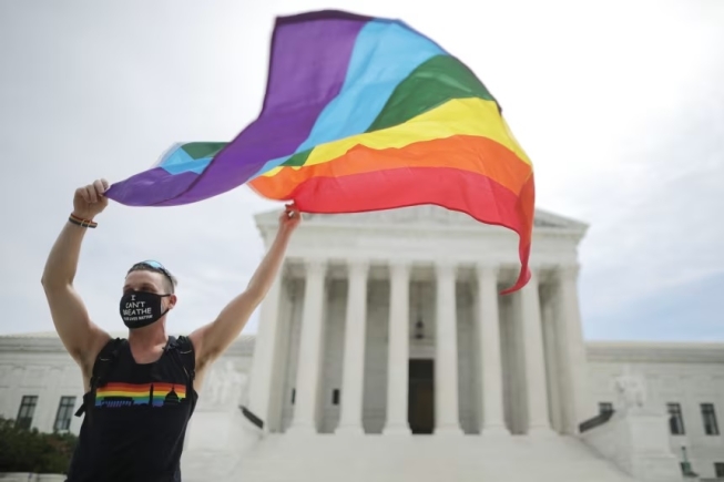 Joseph Fons holding a Pride Flag in front of the Supreme Court on June 15, 2020. Chip Somodevilla/Getty Images