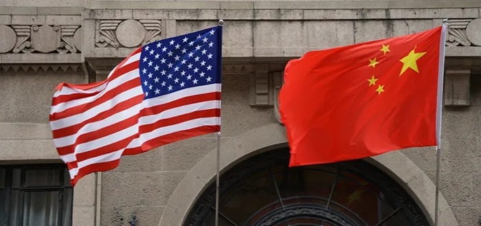 The national flags of the United States and China flutter at the Fairmont Peace Hotel on April 25, 2024, in Shanghai, China. (Wang Gang/VCG via Getty Images)