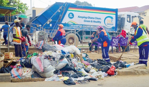 Some of the Zoomlion staff busily working during the clean-up exercise