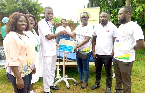 Lily Opoku Mensah (3rd from right), Corporate Social Responsibility Sustainability Officer at the ASA Savings and Loans Limited, presenting the items to Seth Medzida (3rd from left), Nurse Manager of the Kintampo Government Hospital