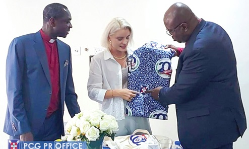 Rt Rev. Dr Abraham Opare Kwakye (right), Moderator of the PCG, presenting  a piece of the bicentennial cloth tp Simone Giger, the Swiss Ambassador to Ghana 