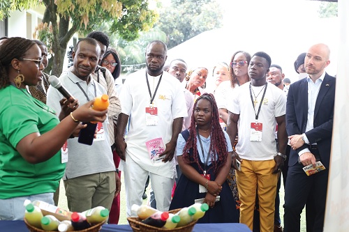 Juliana Dovi (left), CEO, Nature Squeezed, explaining the contents of her product to Khalid Iddrisu (2nd from left), Country Team leader, 2Scale, as other guests look on during a visit to the exhibition stands­­. Picture: BENEDICT OBUOBI