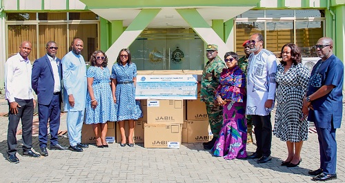 Ernestina Kutin (5th from left), the Chief Human Resource Officer, NIB, presenting the dummy cheque and computers to Brigadier General Maxwell Obuba Mantey, the Director General, NACOC. With them are officials of the NIB and NACOC. Picture: NACOC
