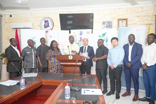 Bishop Gabriel Edoe Kumordji SVD (in cassock), Board Chairman of Lumen Energy Company Ltd, exchanging the MoU with Bob Wang, Director, Digital Power Business Department, Huawei Ghana