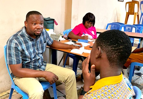 Dr Godwin Asamoah  Ahiakwao Principal Optometrist, Ga North Municipal Hospital, attending to a student at the screening