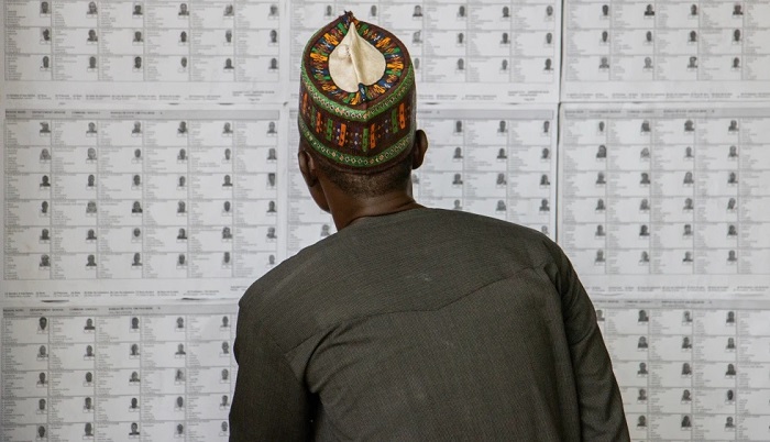 A voter checks his name on the voters' list before casting his ballot at a polling station in Garoua, Cameroon, on 12 October. AP - Welba Yamo Pascal