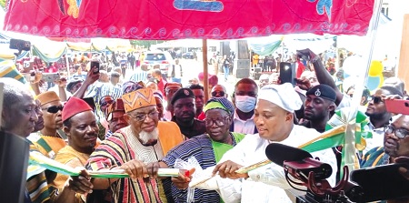 Samuuel Okudzeto Ablakwa (right) Foreign Affairs Minister, being supported by Akamugri Donatus Atanga (2nd from right), Upper East Regional Minister, and Tongraan Kugbilsong Nanlebegtang (2nd from left), the Paramount Chief of the Talensi Traditional Area, to cut the tape to inaugurate the centre